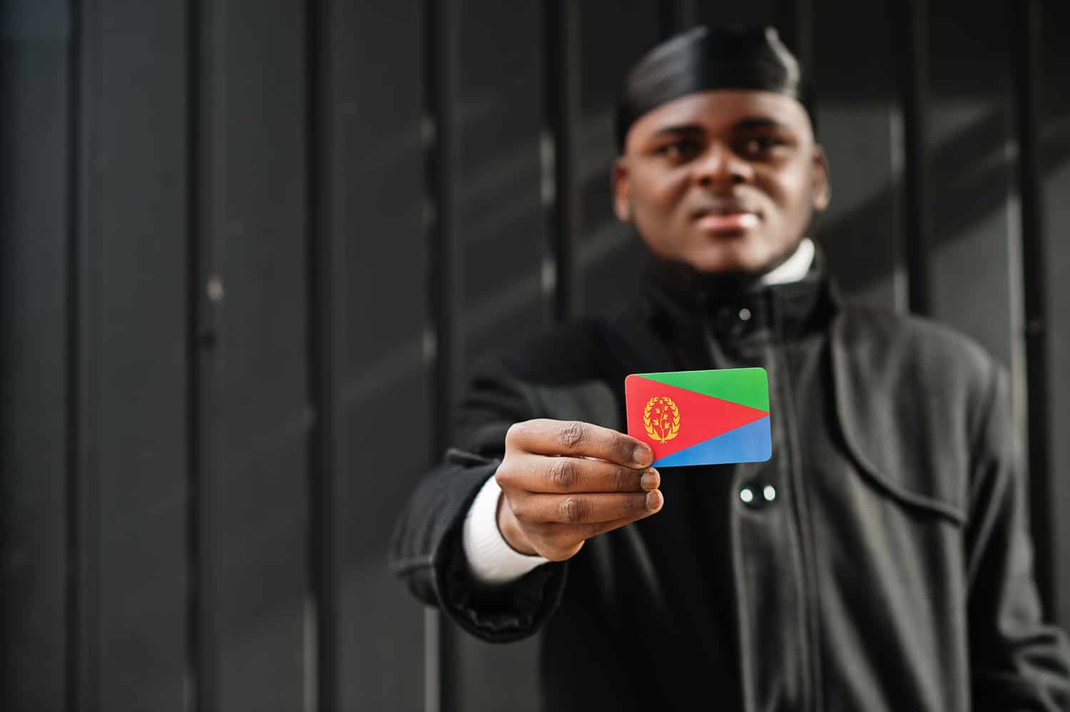 african man wear black durag hold eritrea flag at hand isolated