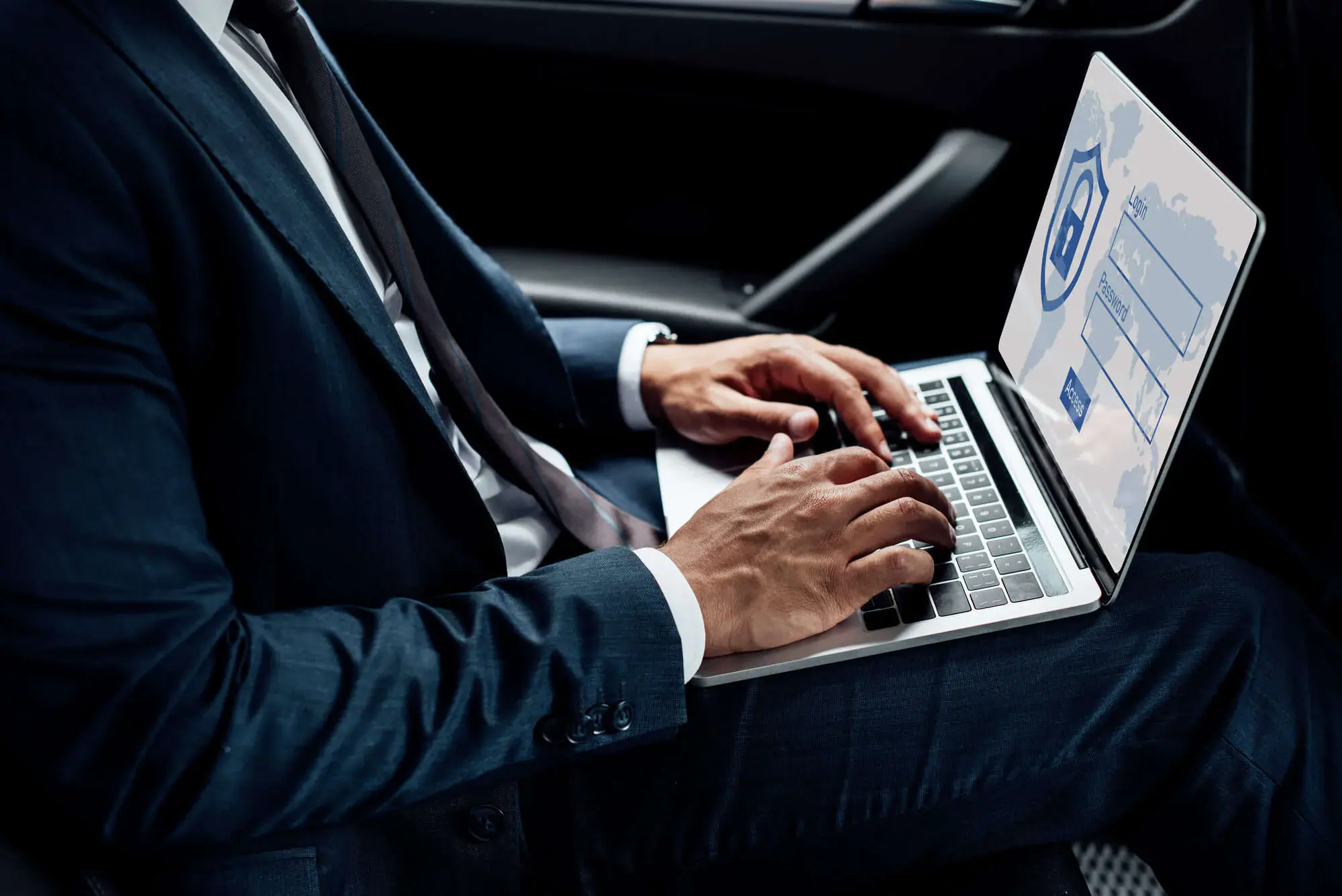 Businessman typing on a laptop with a secure login screen and world map.